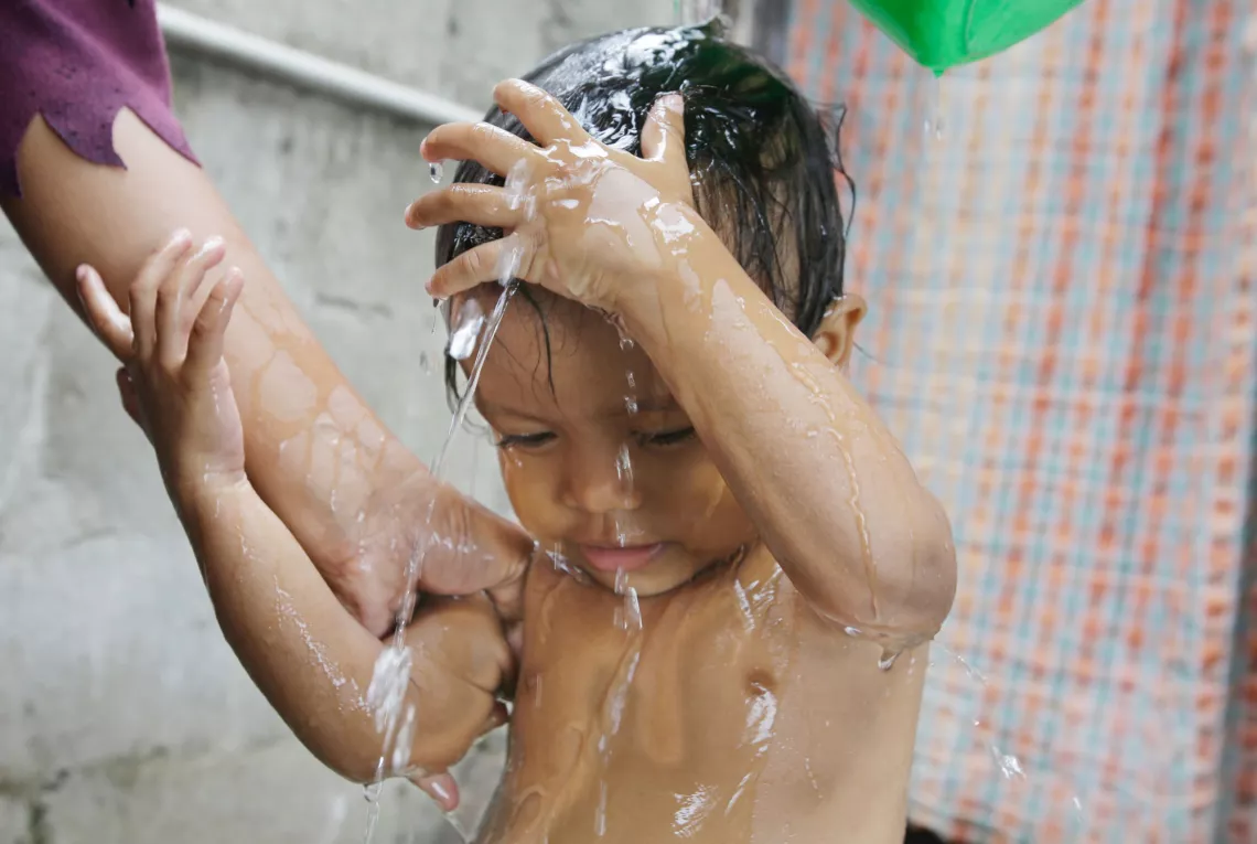 A child given bath with soap and water.