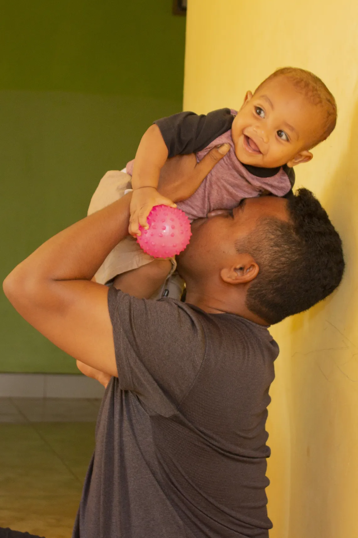 El-Asamau plays with his son