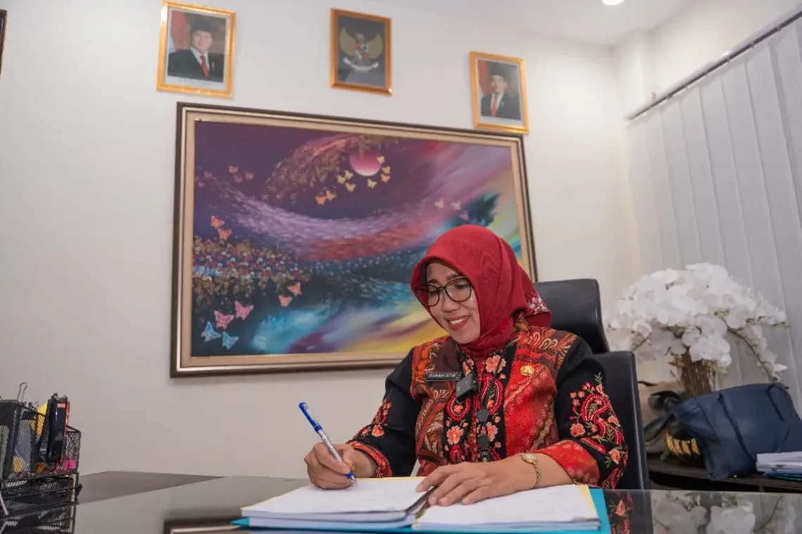 Suhartatik, Head of the High School Education Development Division of the East Java Provincial Education Office, smiles in her office, Surabaya, East Java. 