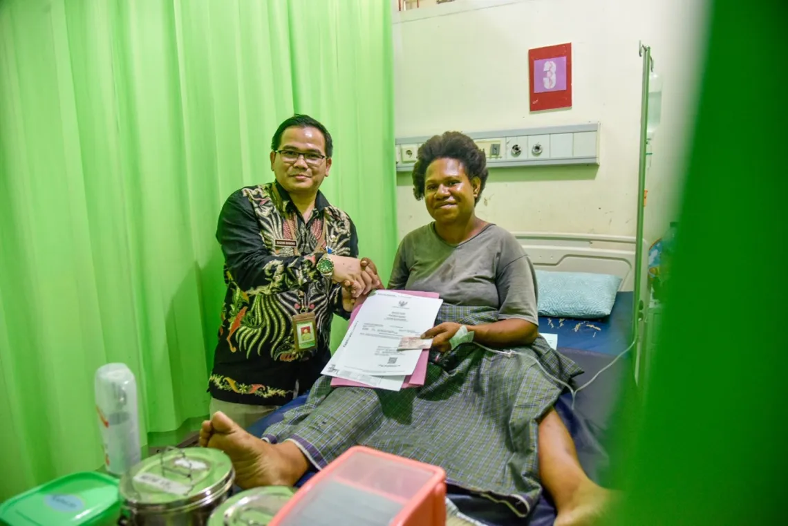 Head of administration of Yowari Hospital, Sugeng Budiono hands Gregorius&rsquo; birth certificate to Cremilda. 