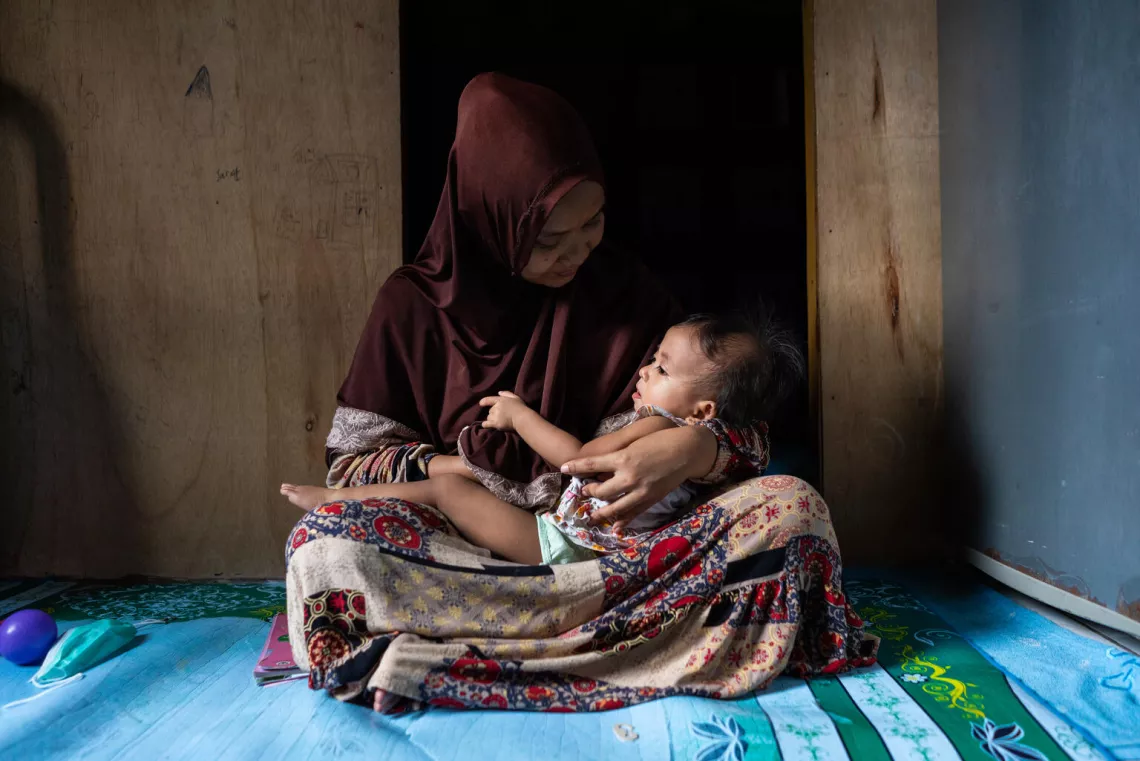 Ayu comforts her daughter