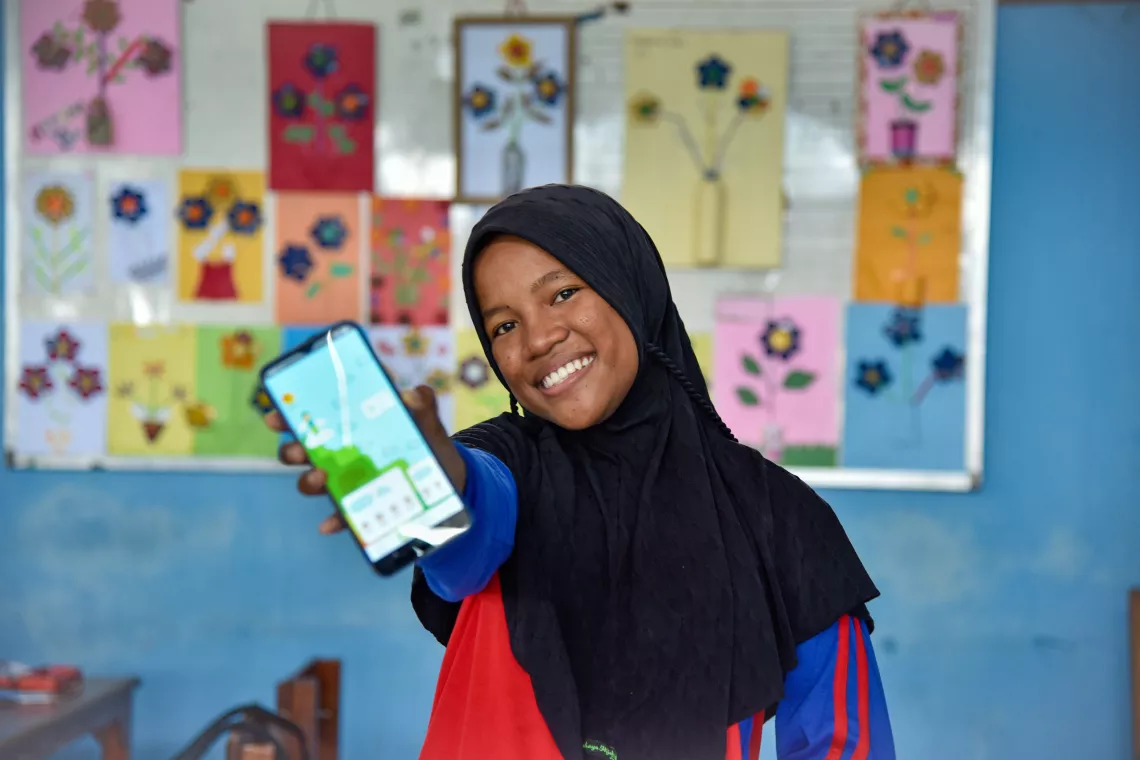 Tia proudly shows her period tracker on her OkyApp inside her classroom in Larantuka, East Florest. 
