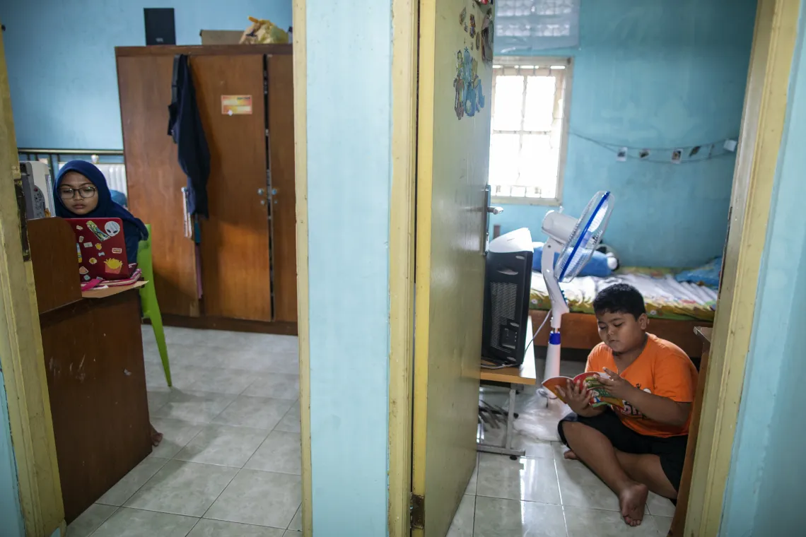 Arkan and her sister study at home while keeping a safe distance
