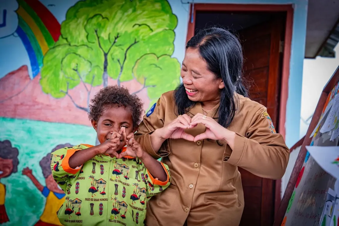 Bertha teaches Gracia, 5, how to make a heart shape at the Sinar Hungku Early Child Education Centre, Arfak Mountains, Papua, on 13 August 2025.