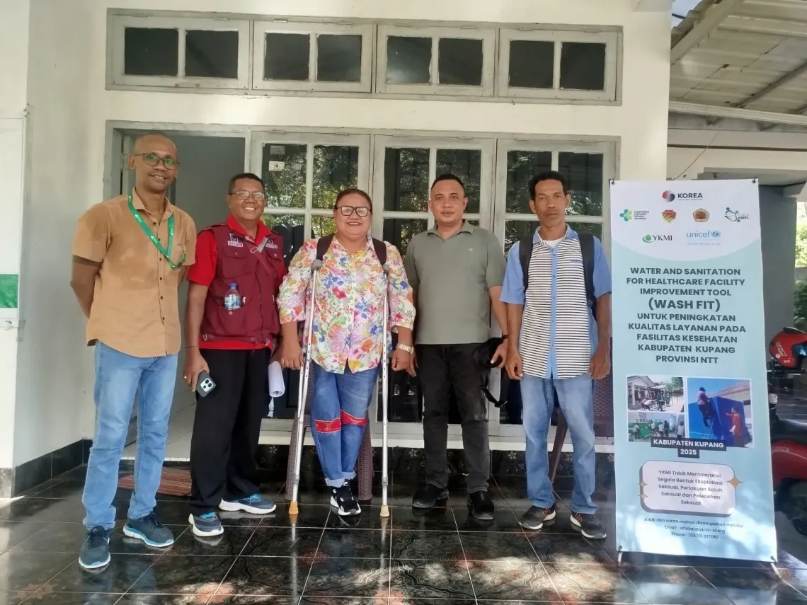 Yomi poses with her team in front of a partner office on 27 May 2025, ahead of the Joint Assessment using the PERIKSA Tool and WASHFIT for GEDSI and Climate Resilience in 26 community health centres across Kupang District. This effort is supported by UNICEF and the Republic of Korea.