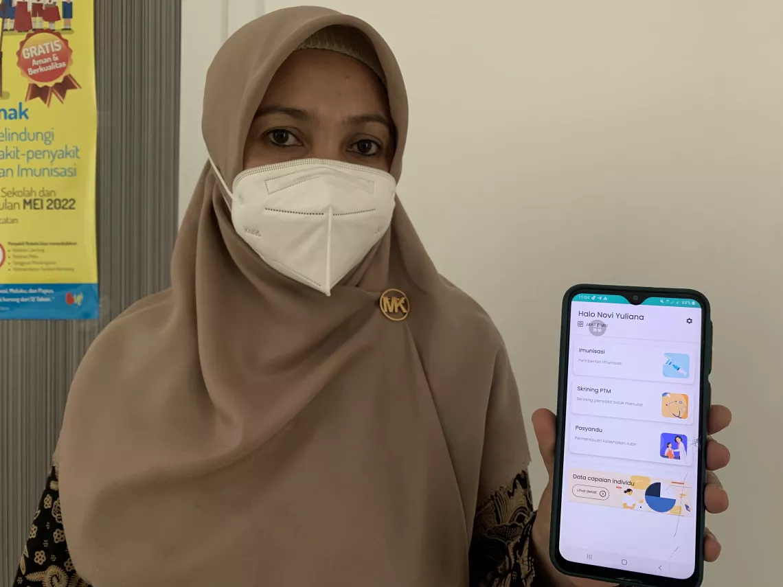 Novi Yuliana, an immunization worker in Banda Aceh shows her ASIK mobile application