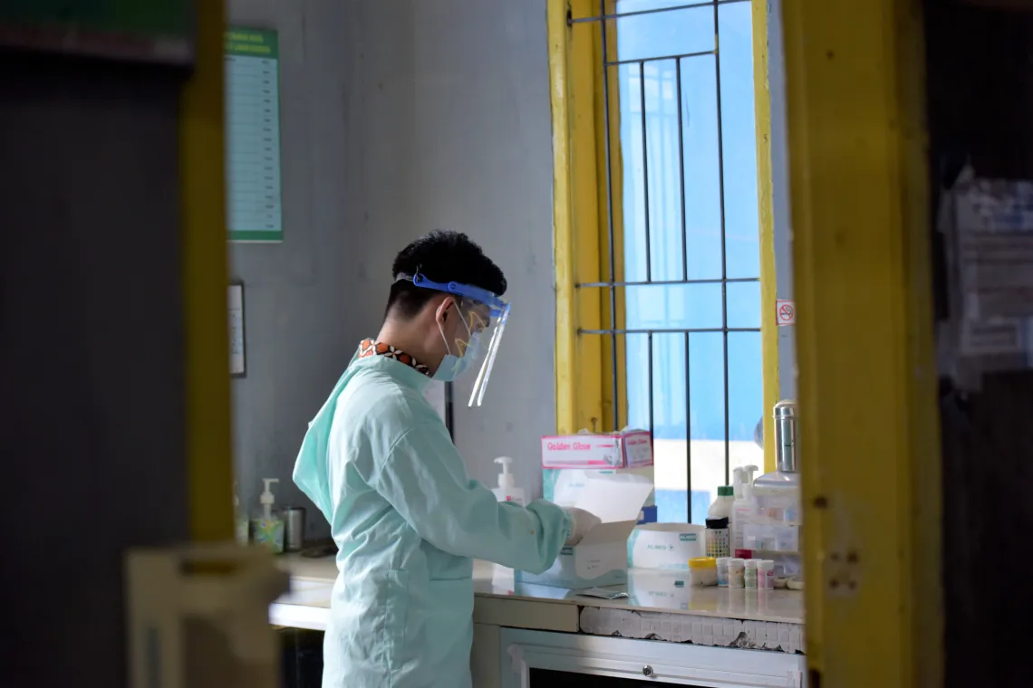 Panca prepares the antigen test kits at Puskesmas Binanga.