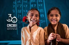 Two girls smiling in the classroom.