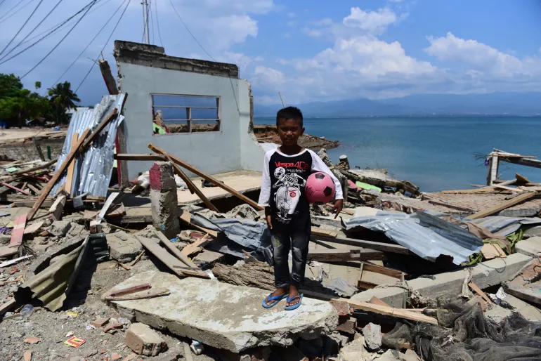 boy amid rubble
