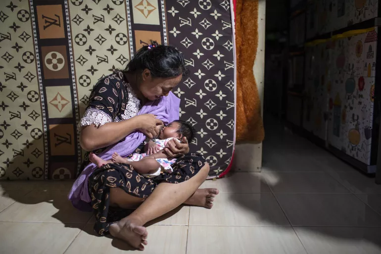 A mother breastfeeds her baby