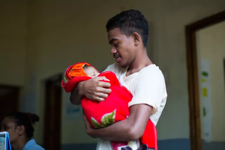 A father holding his baby