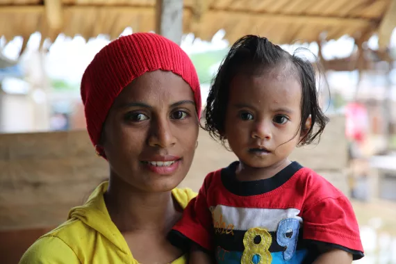 A mother holding her child.
