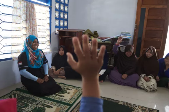 Teacher with children in a classroom.