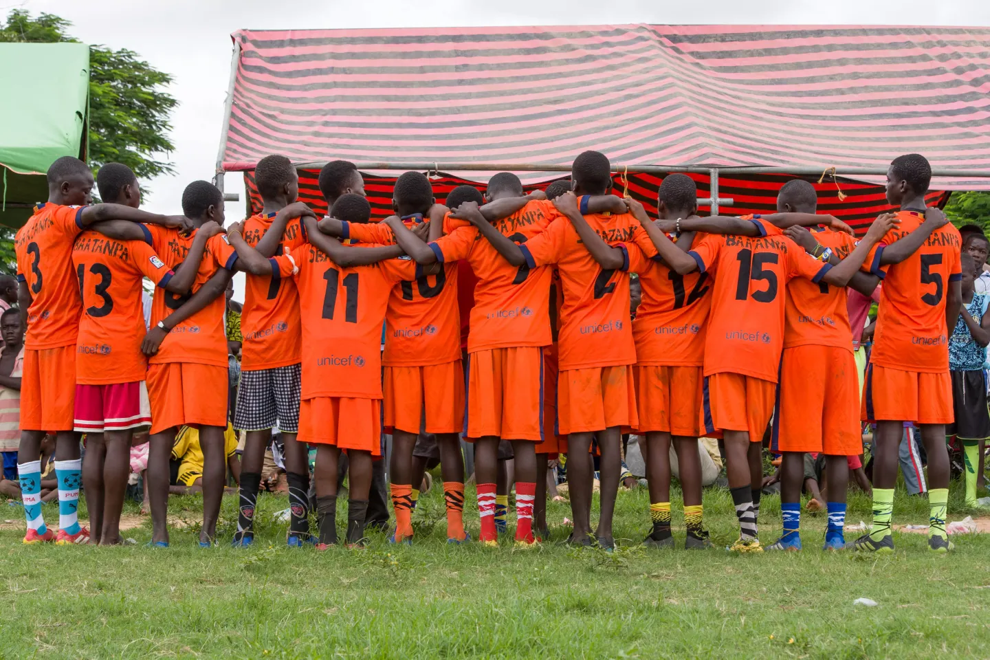 Players of a sports team linking arms