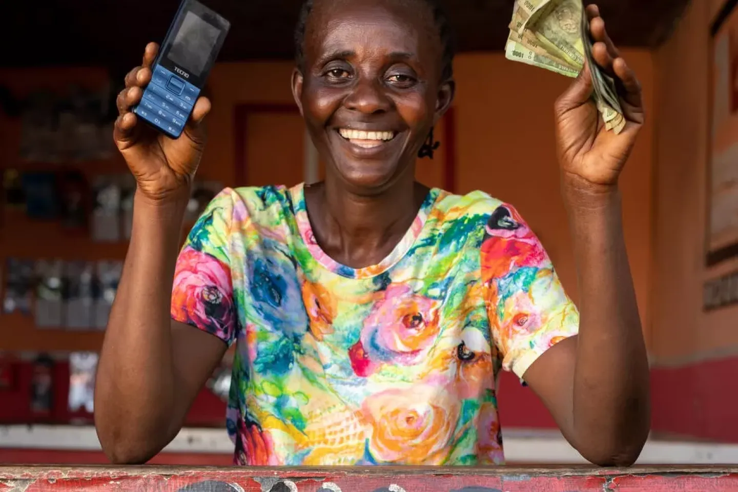Chantal Ngimbi poses in front of a Mpesa shop in the commune of Nsele, on the outskirts of Kinshasa