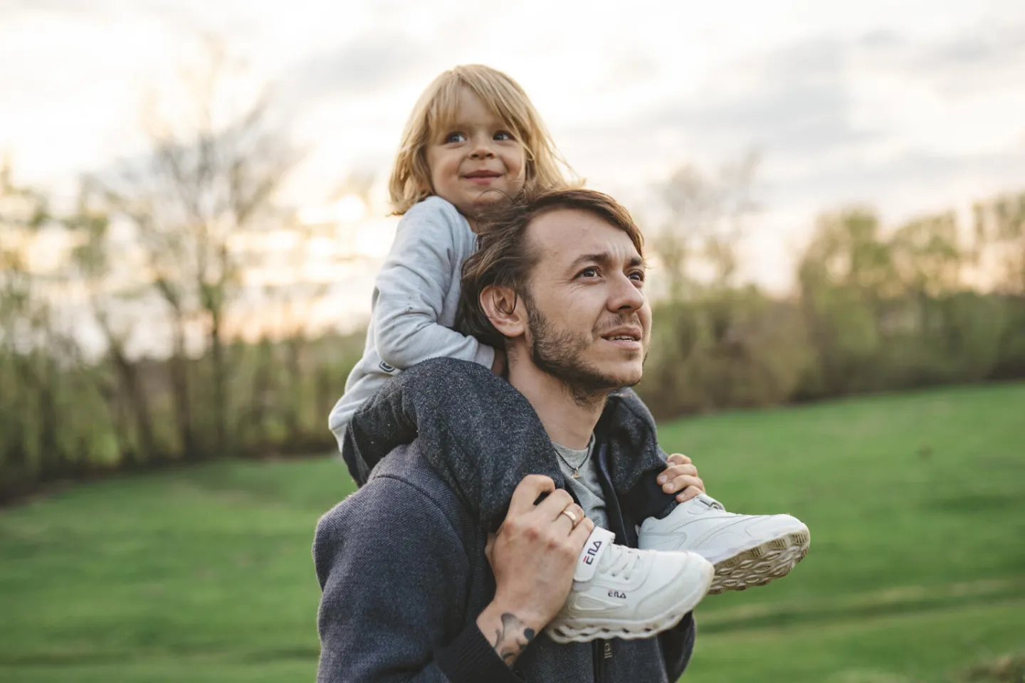 Young Ukrainian child on father's shoulders looking happy 