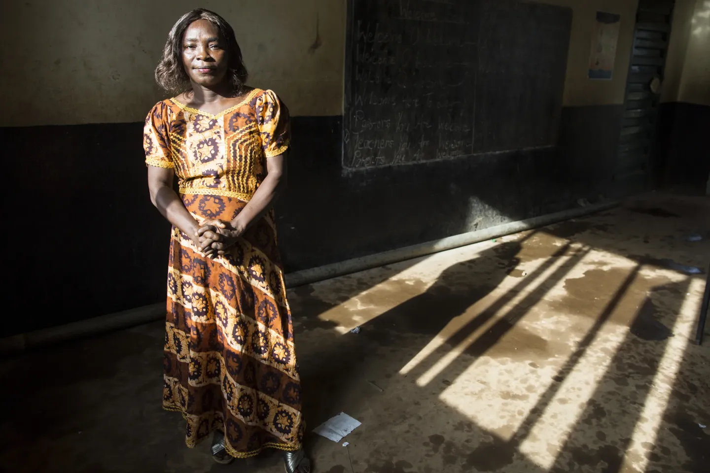 A teachers poses for a photo.