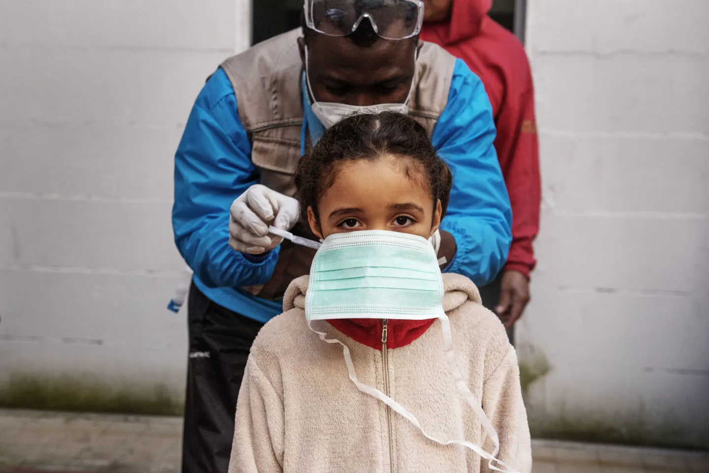 Seven-year-old girl is given a protective mask