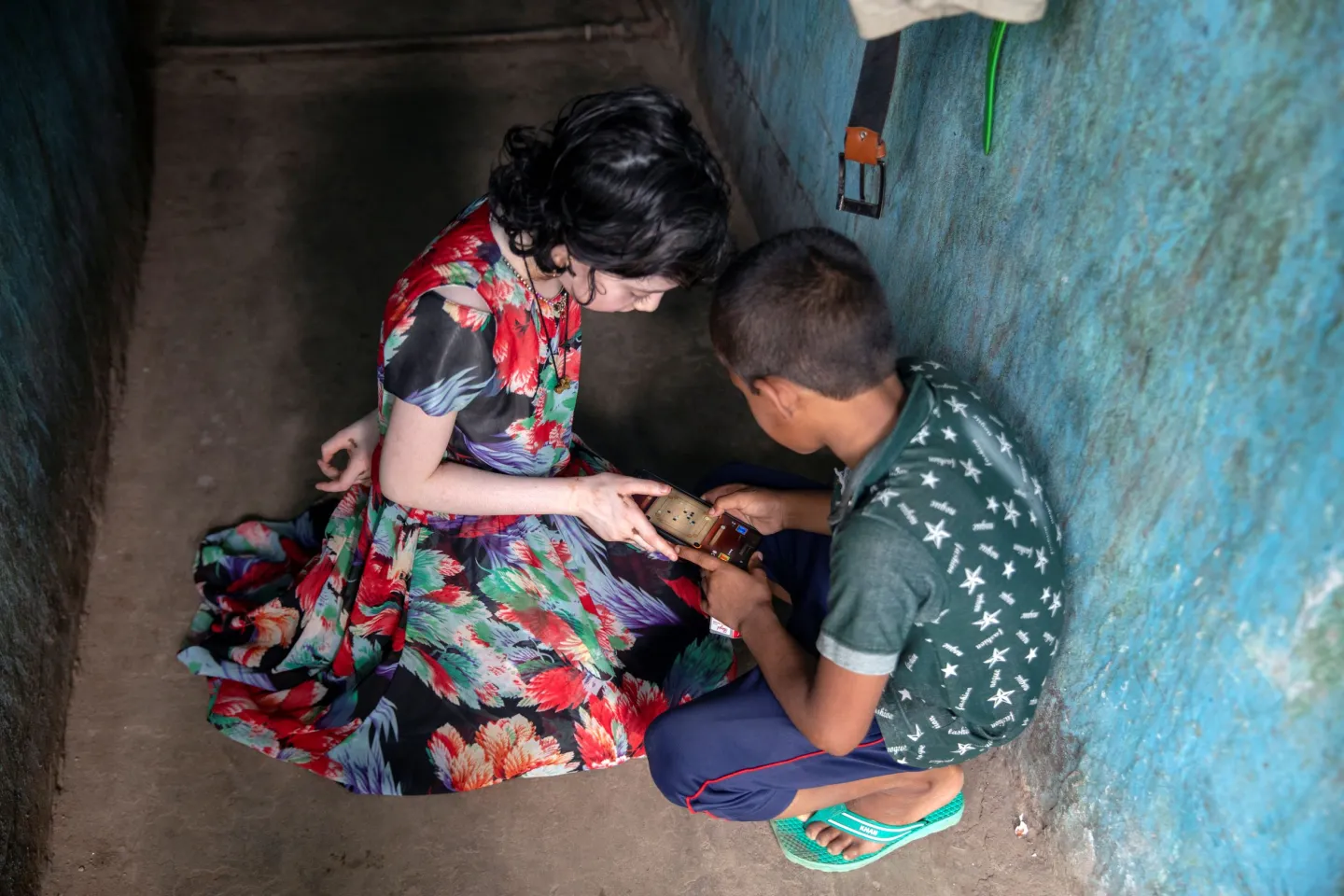 Children using a mobile phone in Bangladesh