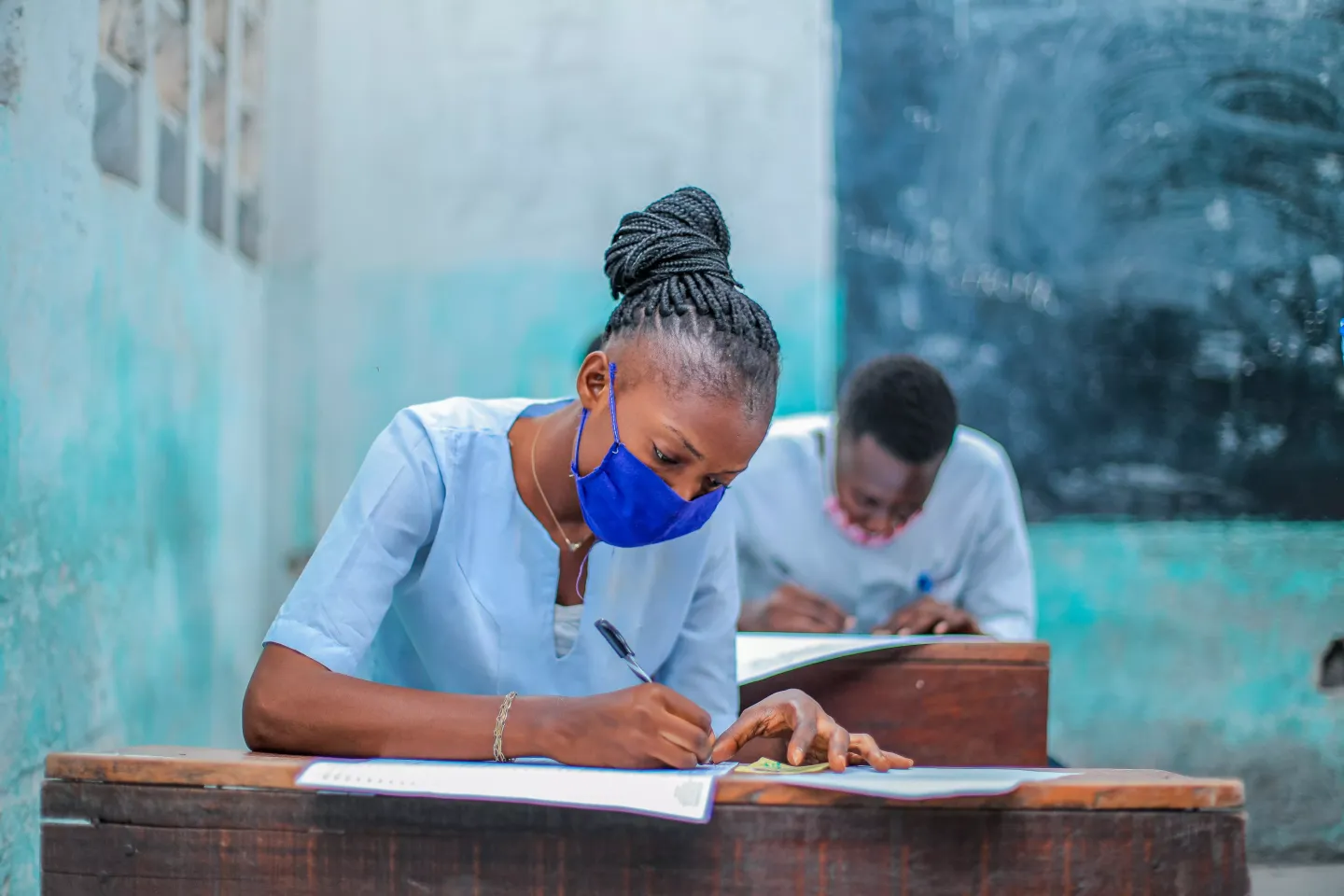 Students sitting exams while wearing protective face masks