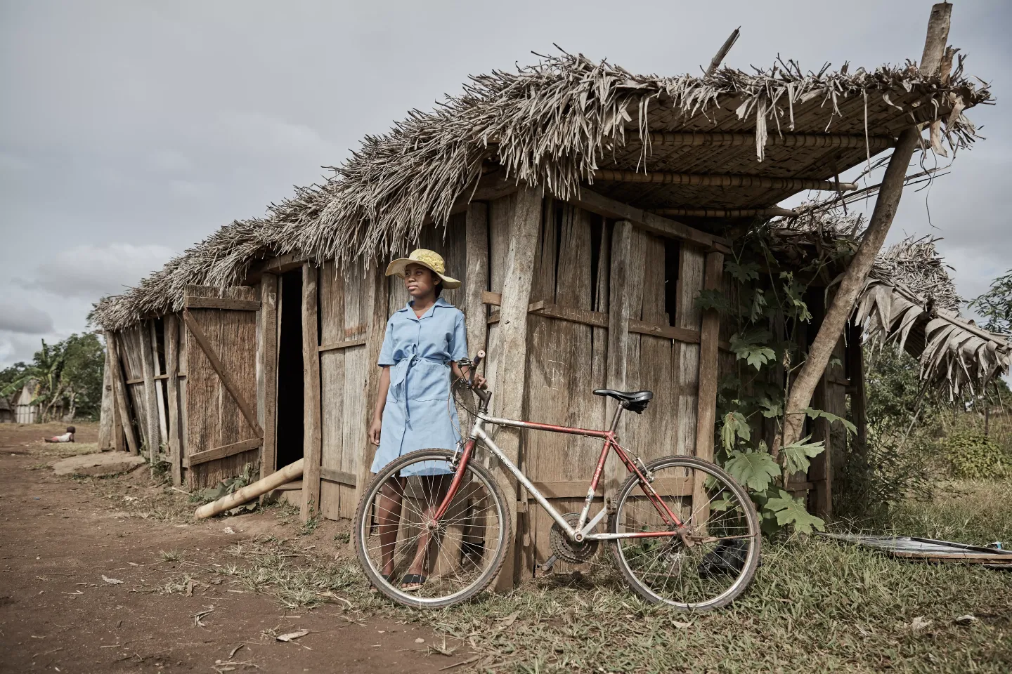 Girl in Madagascar in front of their classroom ravaged by a cyclone