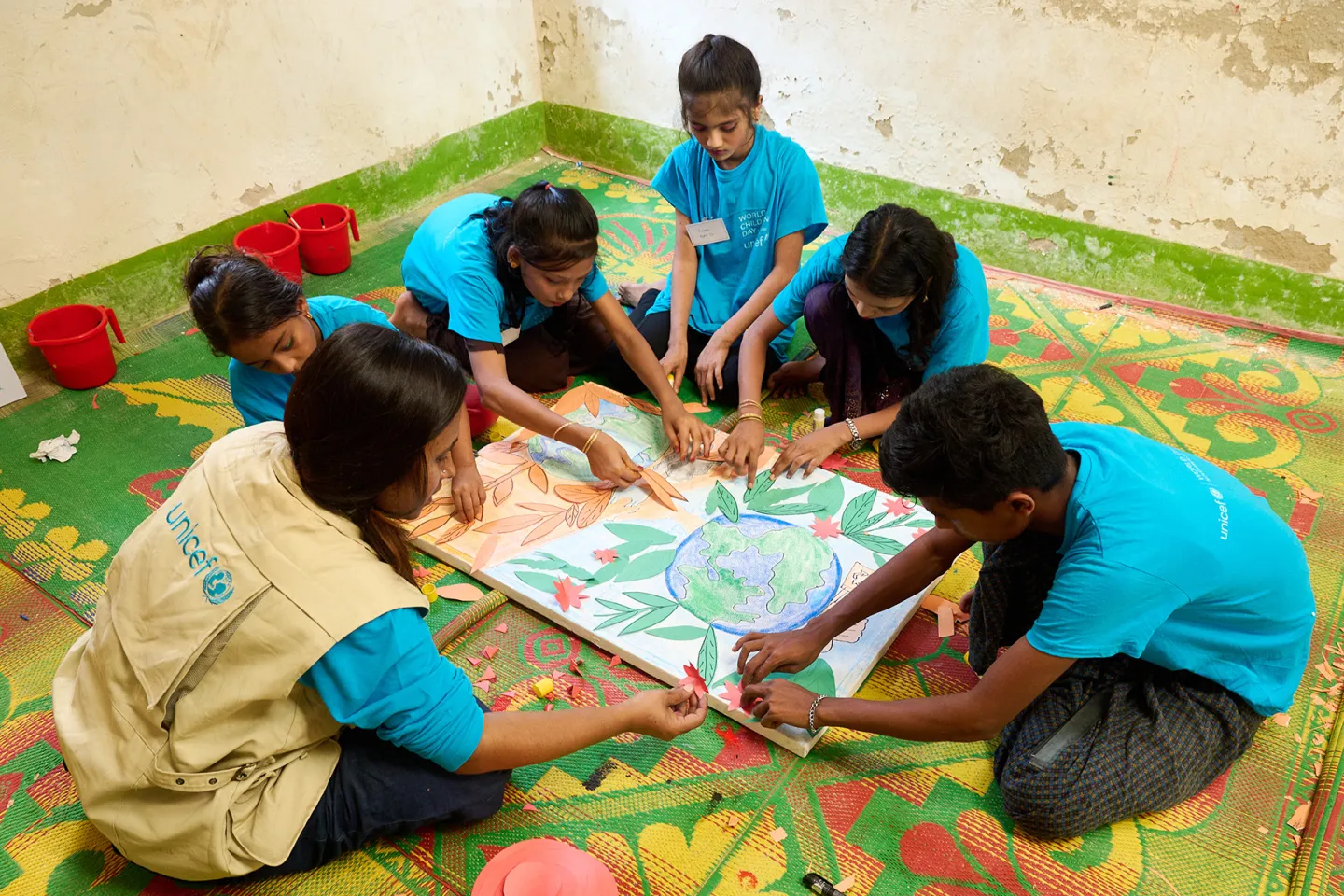 Children in Bangladesh work on an art project to raise awareness about climate change