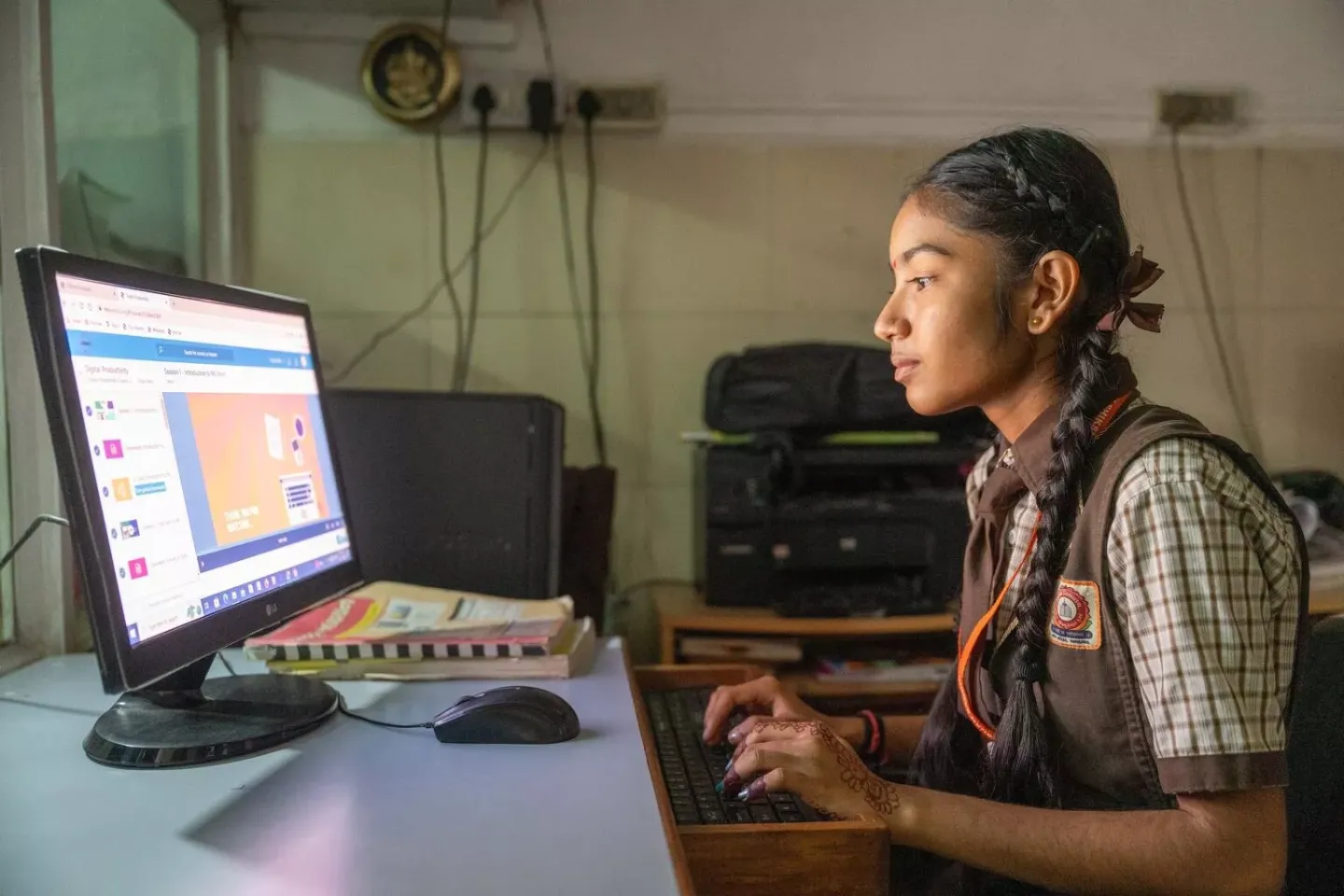 A girl learning on a computer in India