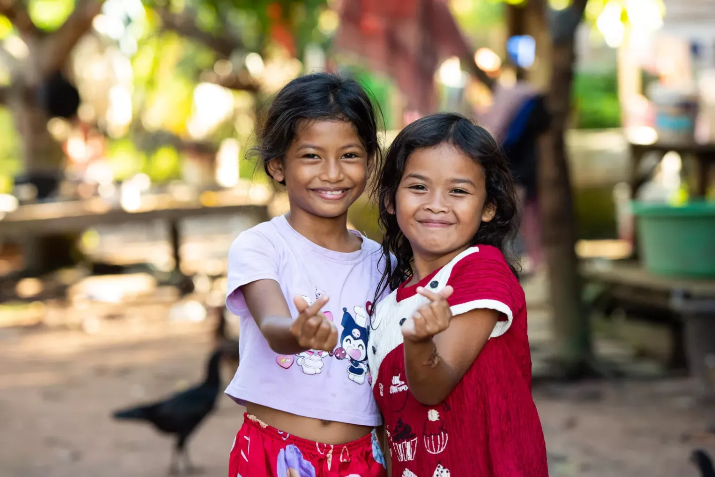 Two young girls facing the camera and smiling