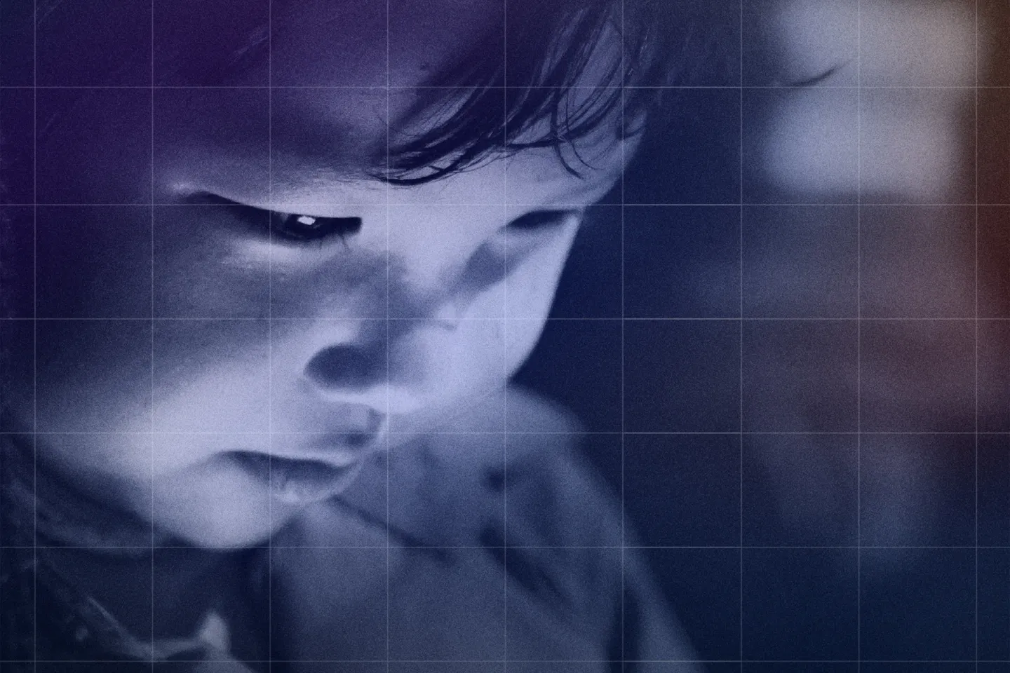 A very young child looking at the screen of his device