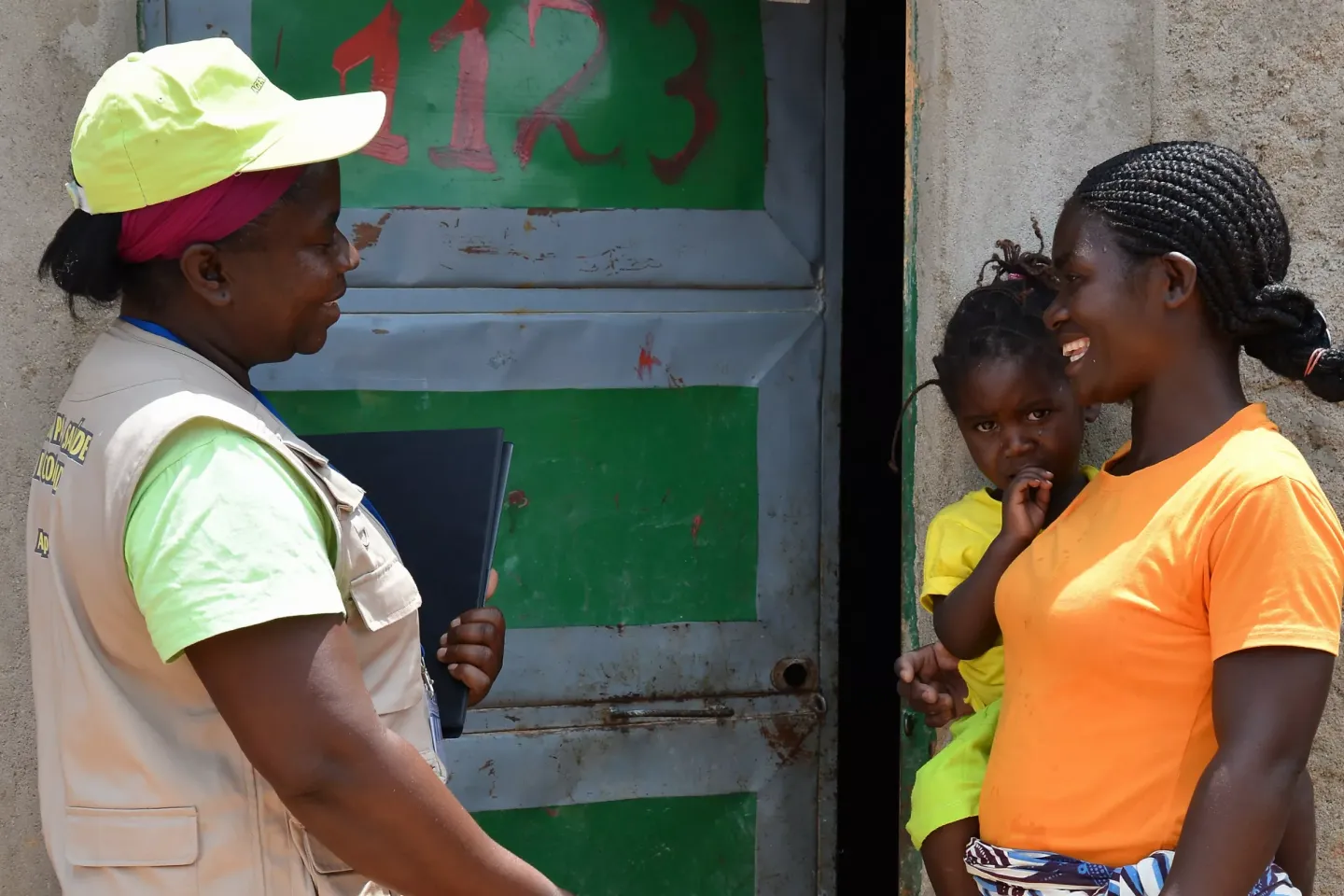 A woman and her daughter talking with another woman in Angola