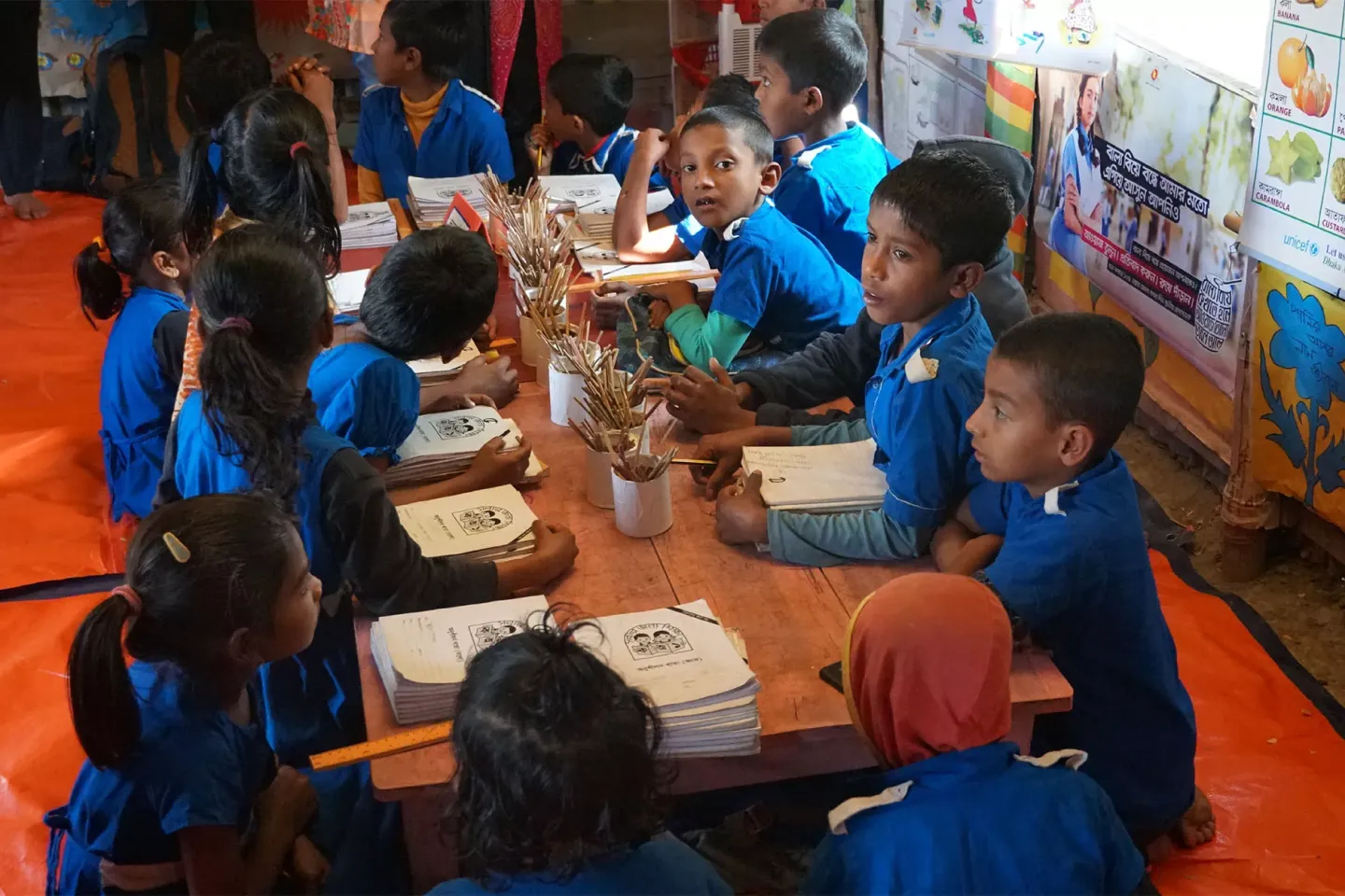 Children sitting around a table with educational materials