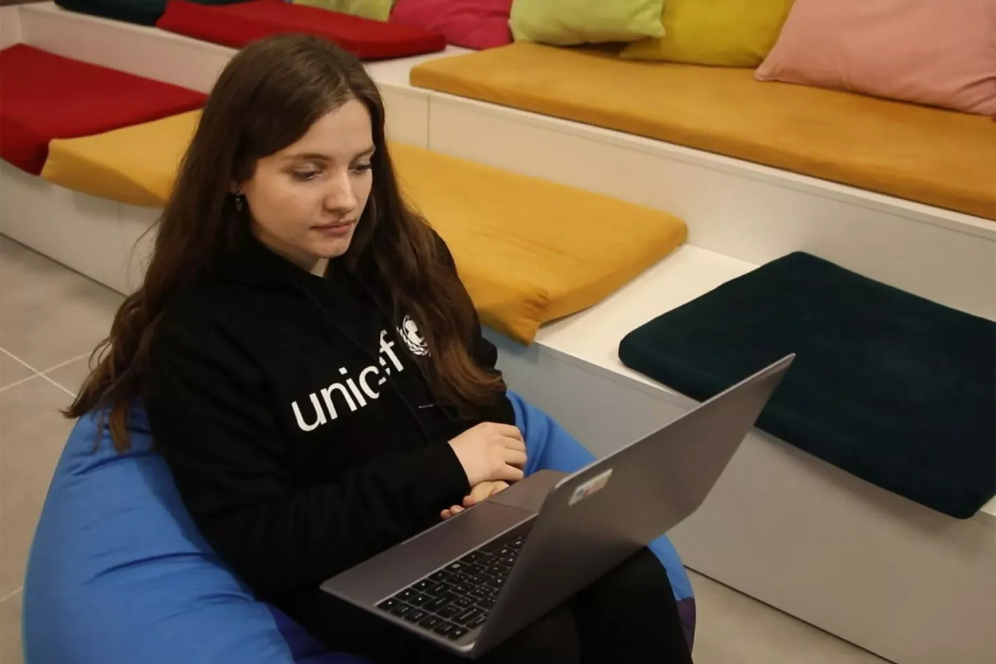 A young woman works on a laptop
