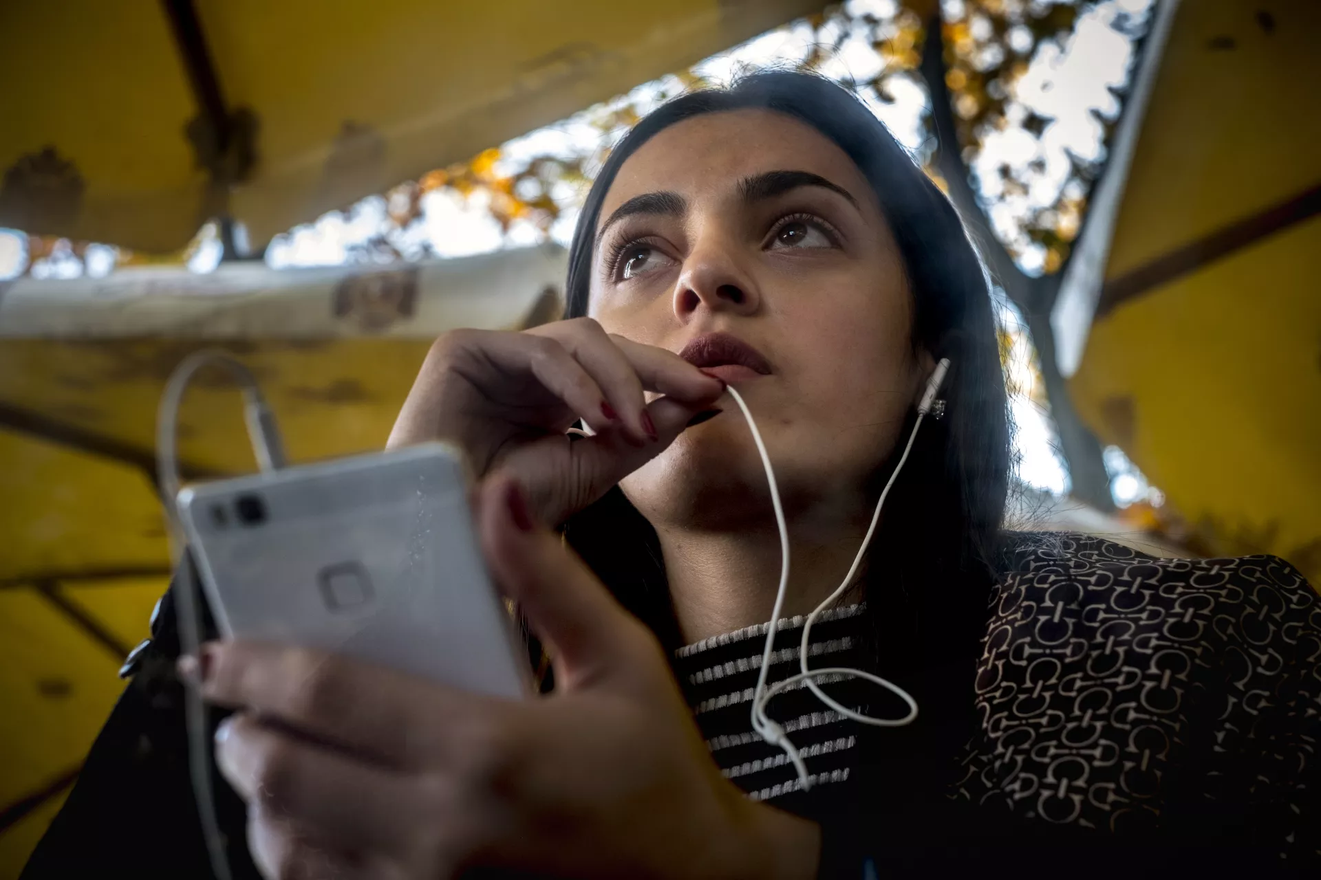 Girl talking on her smartphone with headphones
