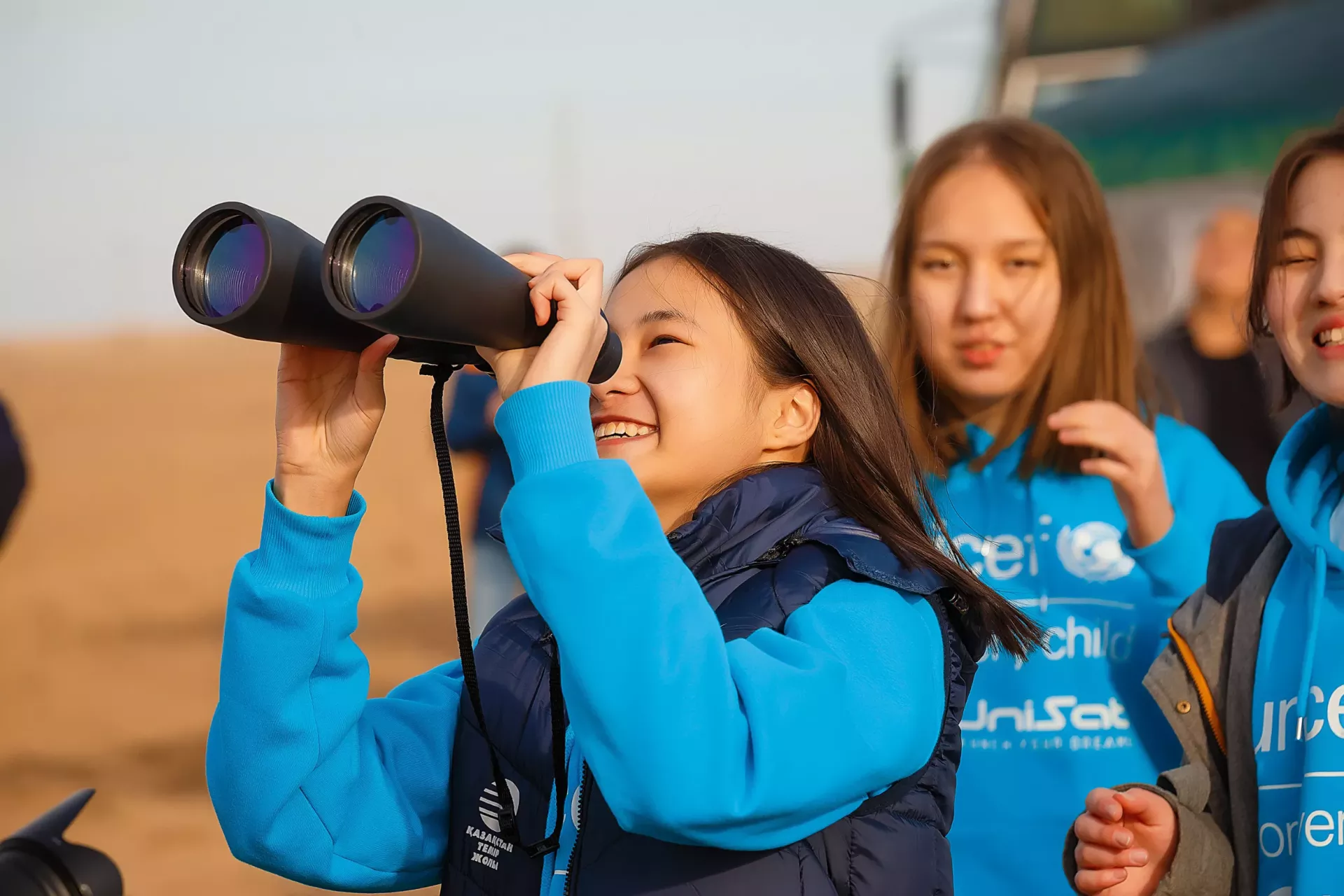 Child looking through binoculars