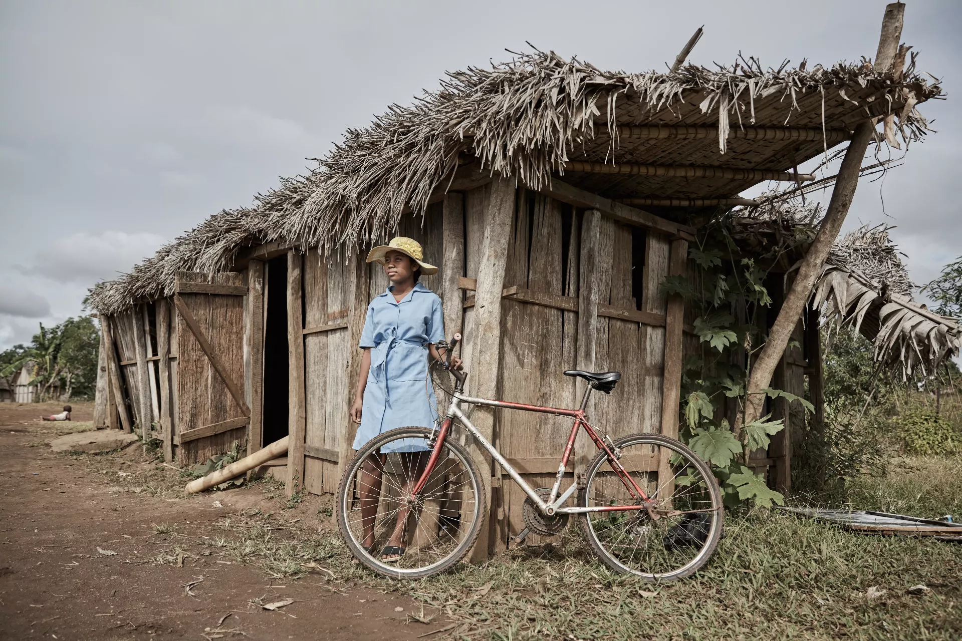 Girl in Madagascar in front of their classroom ravaged by a cyclone