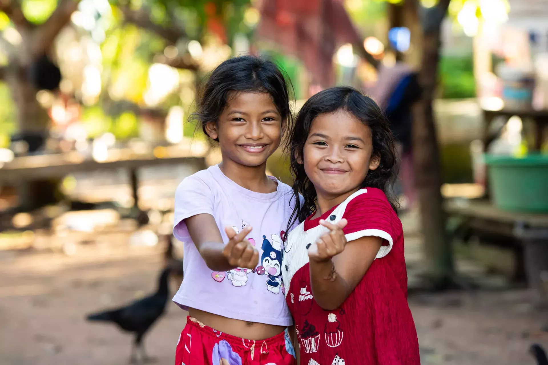 Two young girls facing the camera and smiling