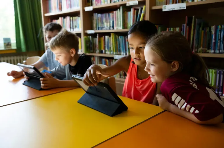 Children looking at a tablet in primary school