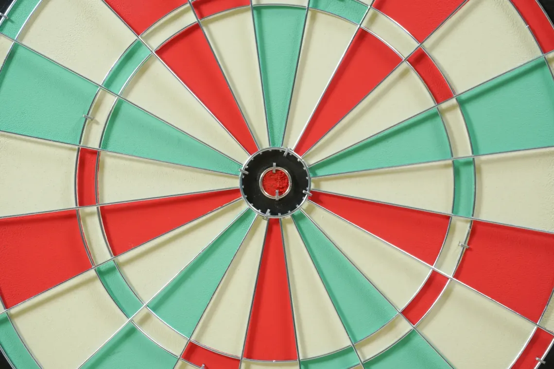 Up close view of a red, white and aqua dartboard