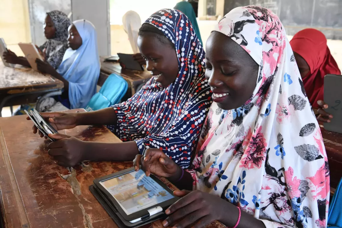 Children using digital tablets at school