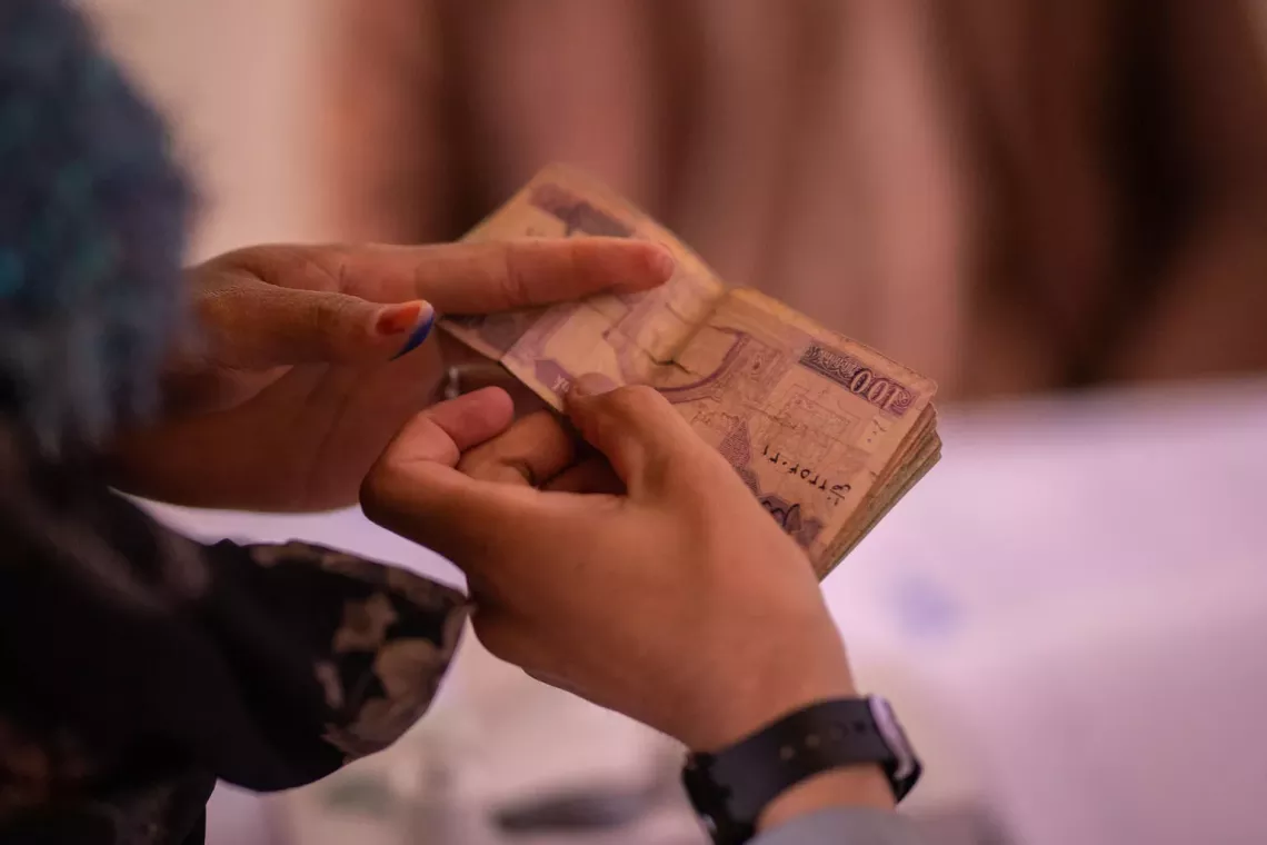 Two hands holding cash
