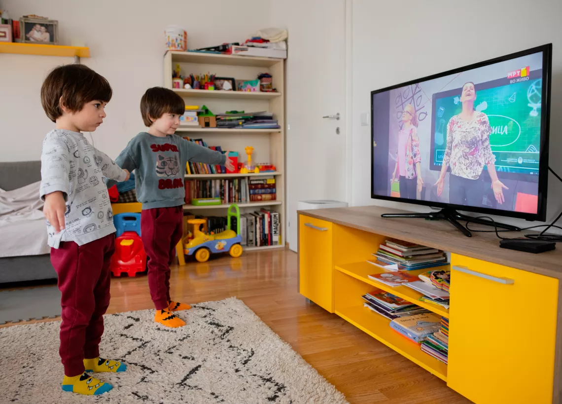 Siblings practice yoga for children with a classroom programme broadcast national television