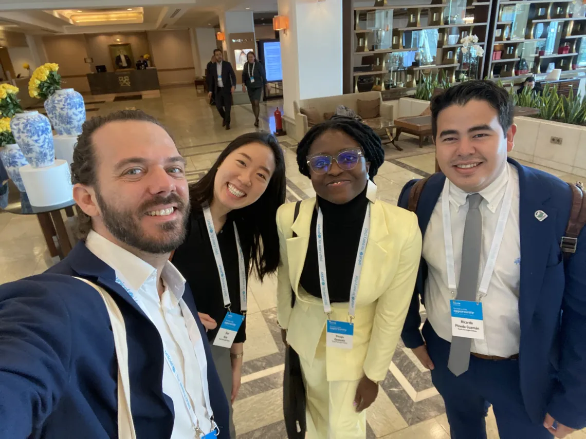 Shai Naides takes a selfie with three UNICEF Youth Foresight Fellows at the 2023 Global Leadership Meeting
