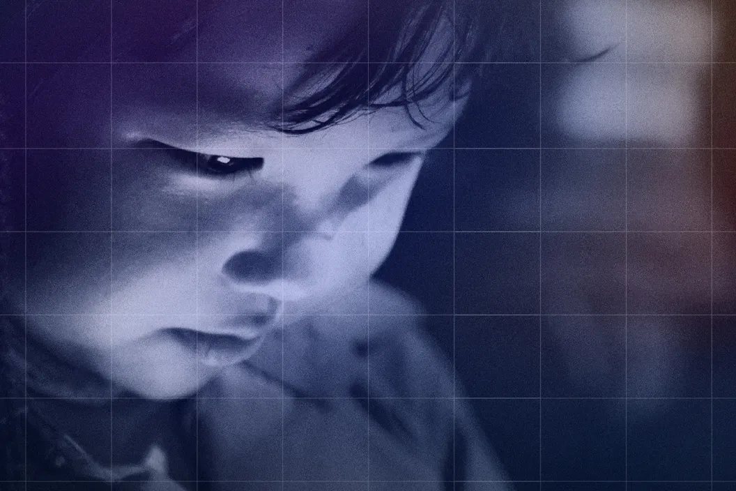 A very young child looking at the screen of his device