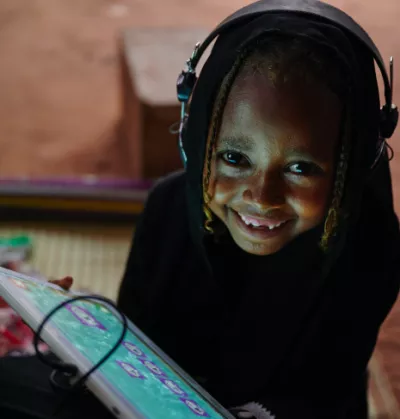 A girl using her tablet at the UNICEF supported Debate e-Learning Centre in Eastern Sudan.