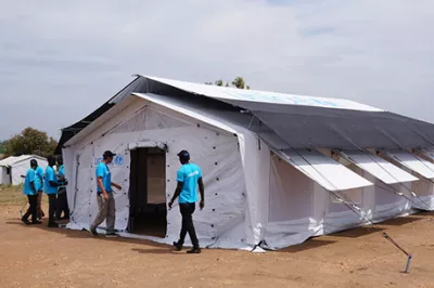 Two men inspect a tent
