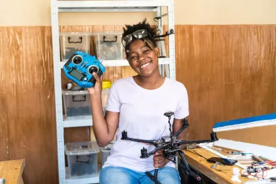 girl holding remote control and drone