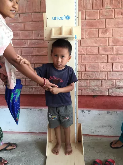 Rusuna Tamang, 4, holds his mother&rsquo;s hand while getting his height measured at UNICEF-supported out-patient therapeutic programme (OTP) clinic in Kamalamai Municipality in Sindhuli district.