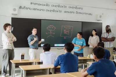 Arm delegations are introducing the smart black board and air quality monitoring sensor at Santiphab Secondary School, Arm visit to Laos 