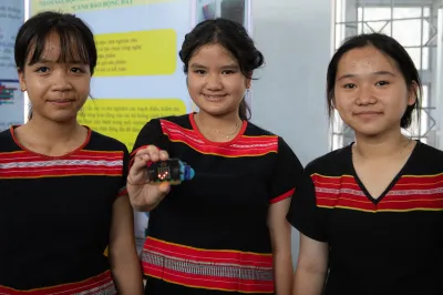 Girls holding AI powered learning device