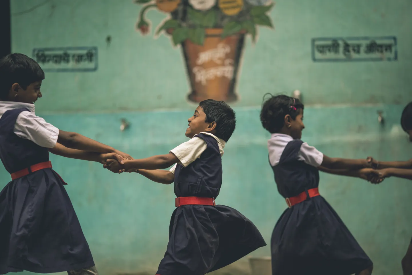 Children holding each others arms 